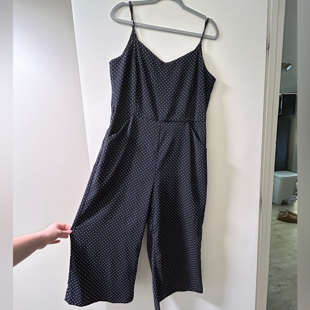 Navy wide leg jumpsuit with white polka dots and pockets